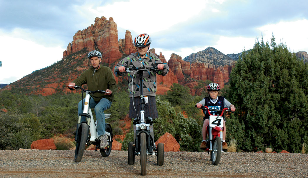 Father and two sons riding bikes in Sedona