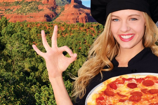 Blonde woman holding a pizza with the Sedona landscape in the background